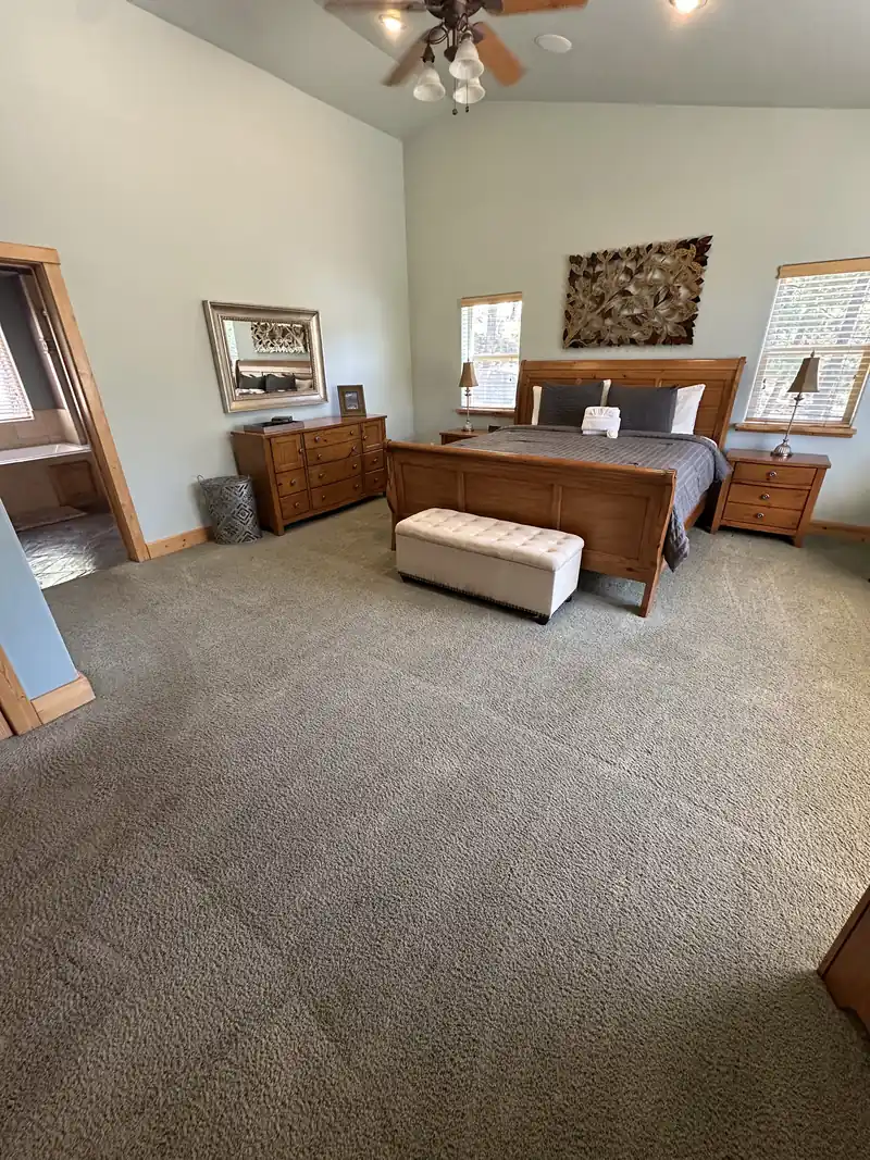 Bedroom with grey carpet before cleaning, the pile flat and matted